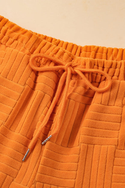 Oranje getextureerde tanktop en broek met wijde pijpen