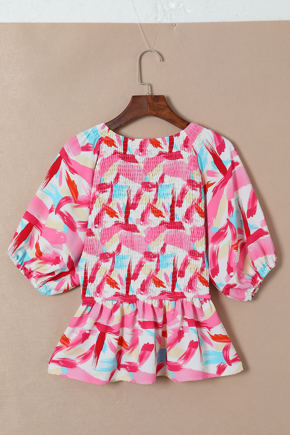 Roze peplumtop met abstracte print en pofmouwen