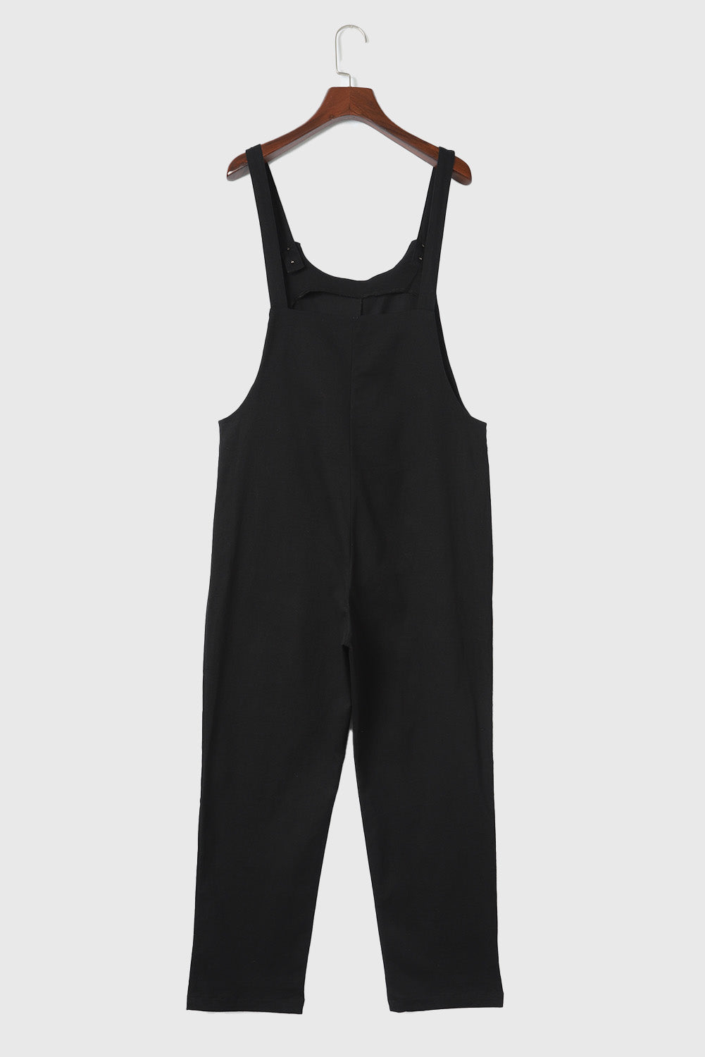 Zwarte cropped jumpsuit met knoopriemen en zakken