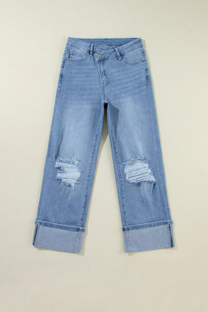 Schemerblauwe asymmetrische gescheurde jeans met knoopsluiting en hoge taille