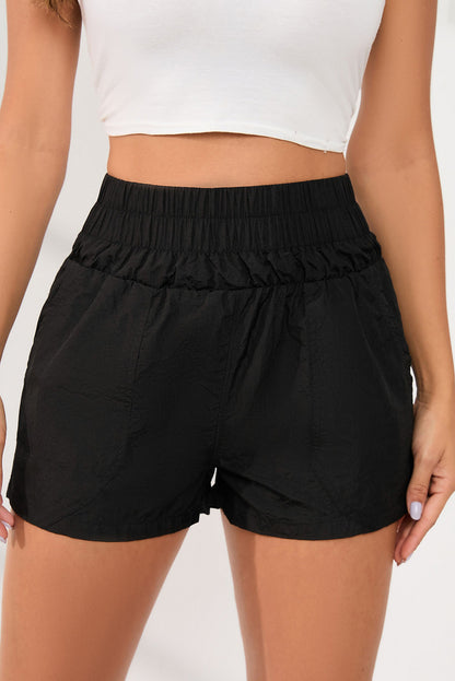 Zwarte elastische short met hoge taille en zijzakken