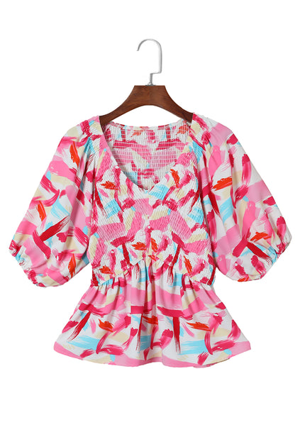 Roze peplumtop met abstracte print en pofmouwen