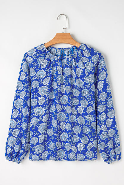 Blauwe blouse met ingekerfde V-hals en lange mouwen met bloemen