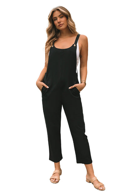 Zwarte cropped jumpsuit met knoopriemen en zakken