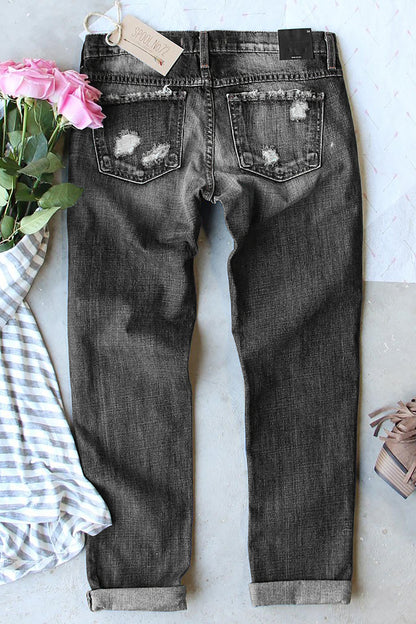 Grijze versleten jeans met zakken met knopen