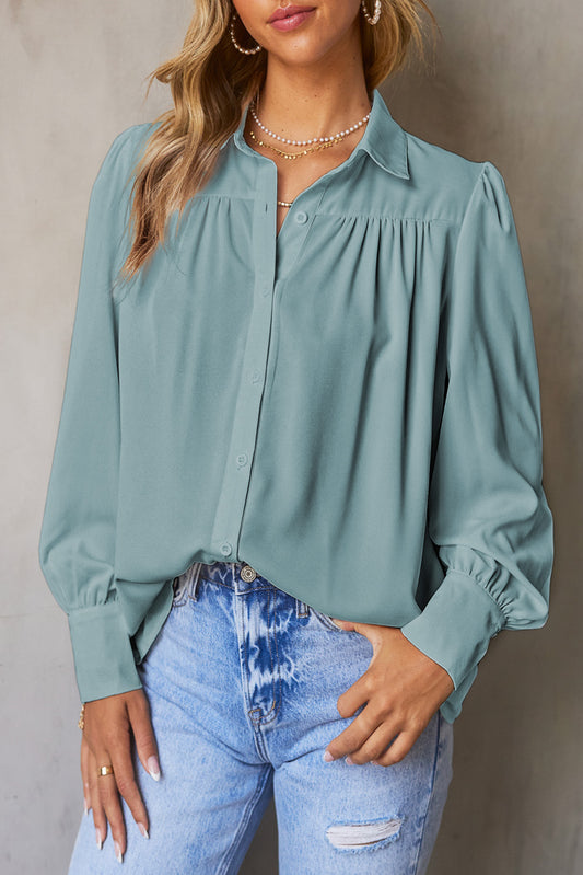 Hemelsblauwe effen kleur blouse met knoopjes en pofmouwen