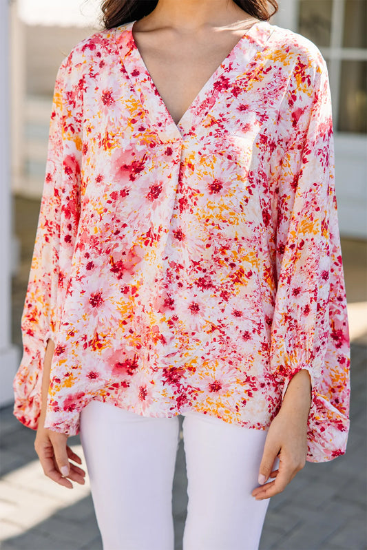 Roze, met bloemen bedrukte blouse met V-hals en bubbelmouwen