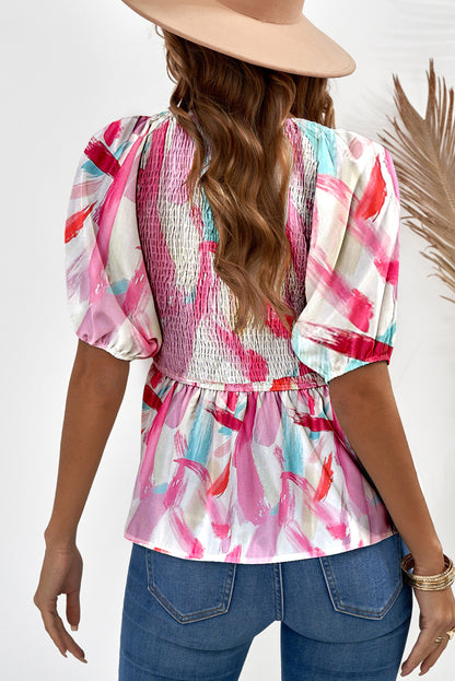 Roze peplumtop met abstracte print en pofmouwen