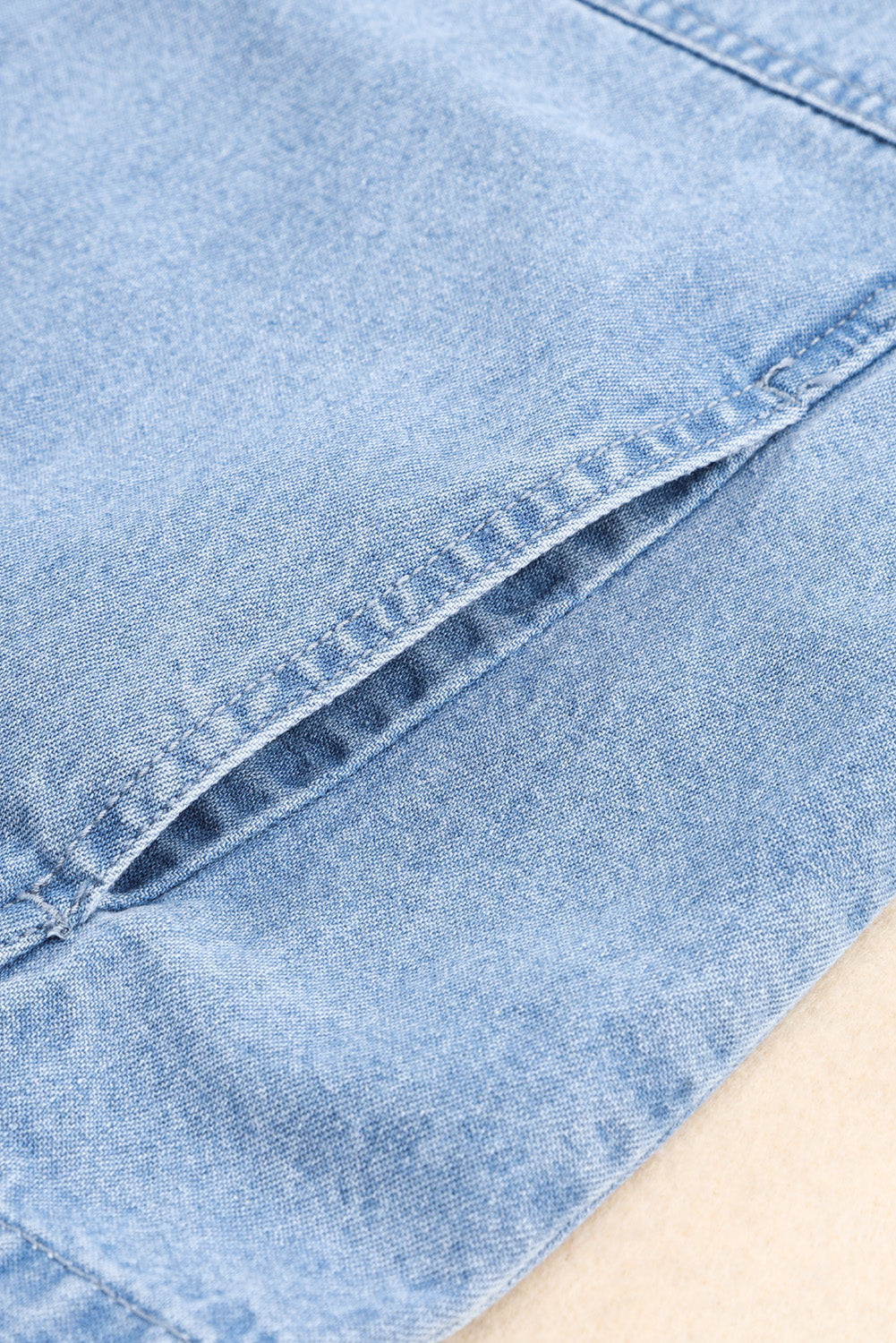 Hemelsblauw denim jack met oprolbare tabmouw en knoopsluiting met zak