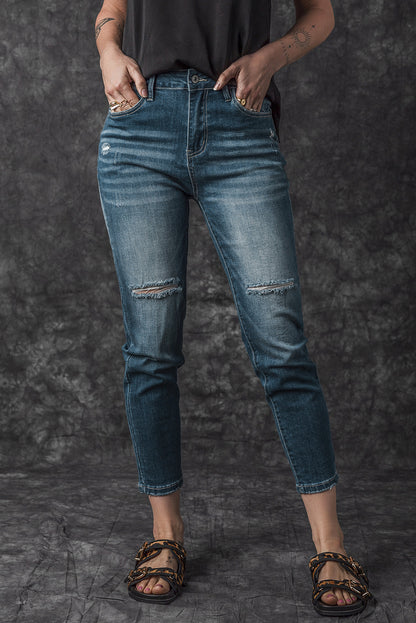 Blauwe noodlijdende gescheurde skinny jeans