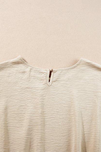 Beige gekreukelde crop-T-shirt met elastische zoom en broek met wijde pijpen