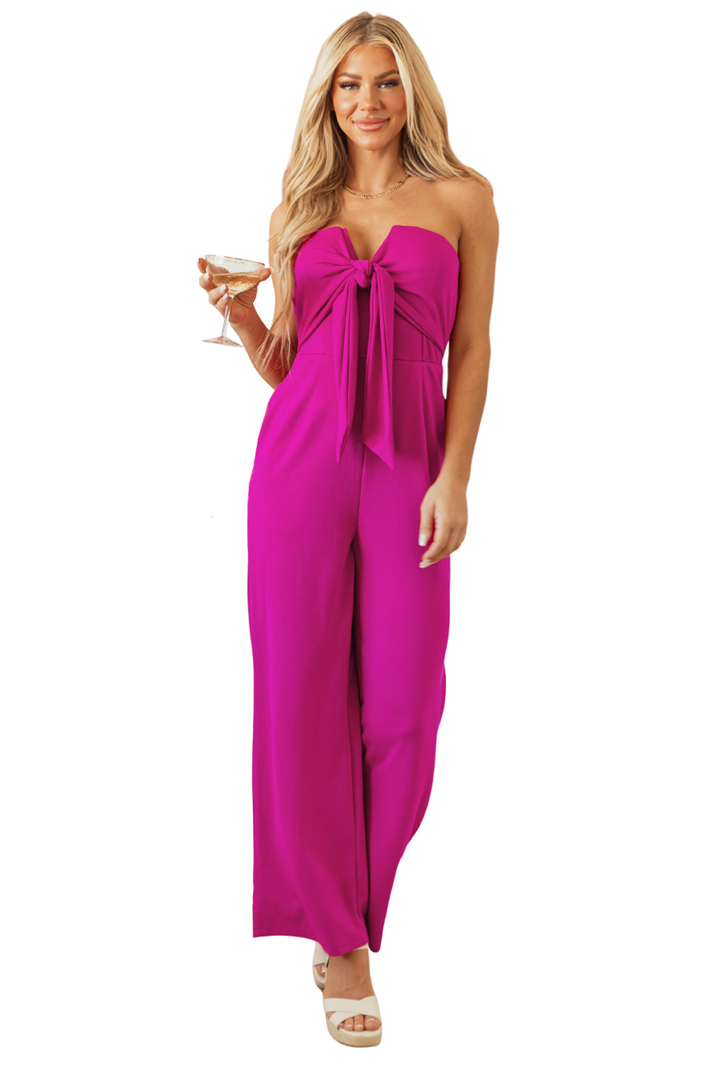 Felroze strapless jumpsuit met strik en wijde pijpen