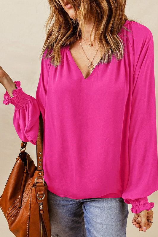 Roze geplooide blouse met V-hals en gezwollen mouwen