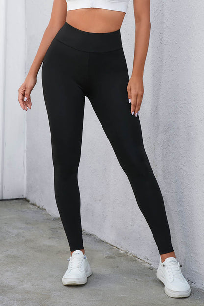 Zwarte legging met gekruiste buikcontrole en hoge taille