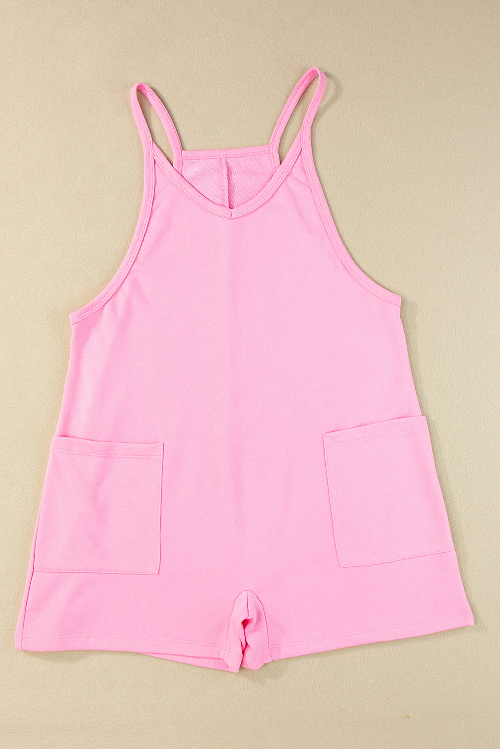 Roze mouwloze jersey romper met V-hals en zakken