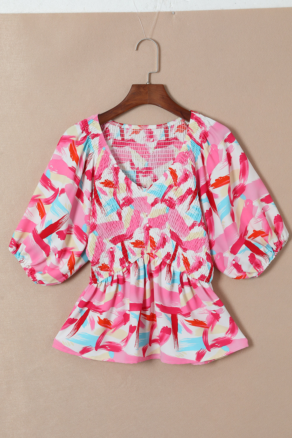 Roze peplumtop met abstracte print en pofmouwen