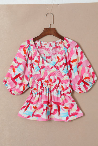 Roze peplumtop met abstracte print en pofmouwen