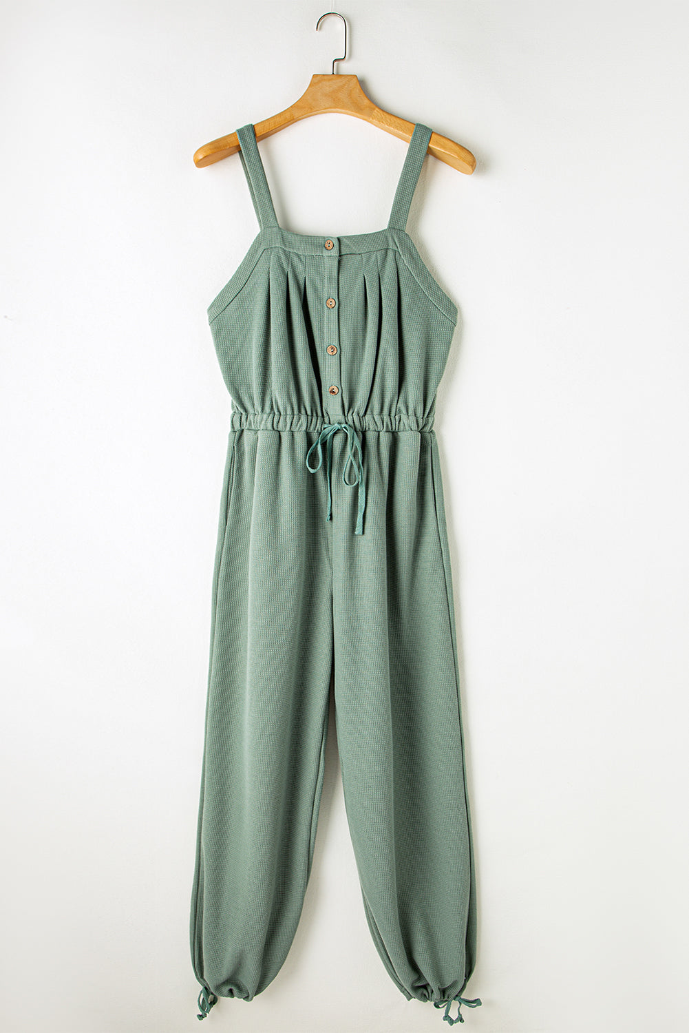 Mosgroene jumpsuit met geknoopte bandjes en knooptextuur met trekkoord