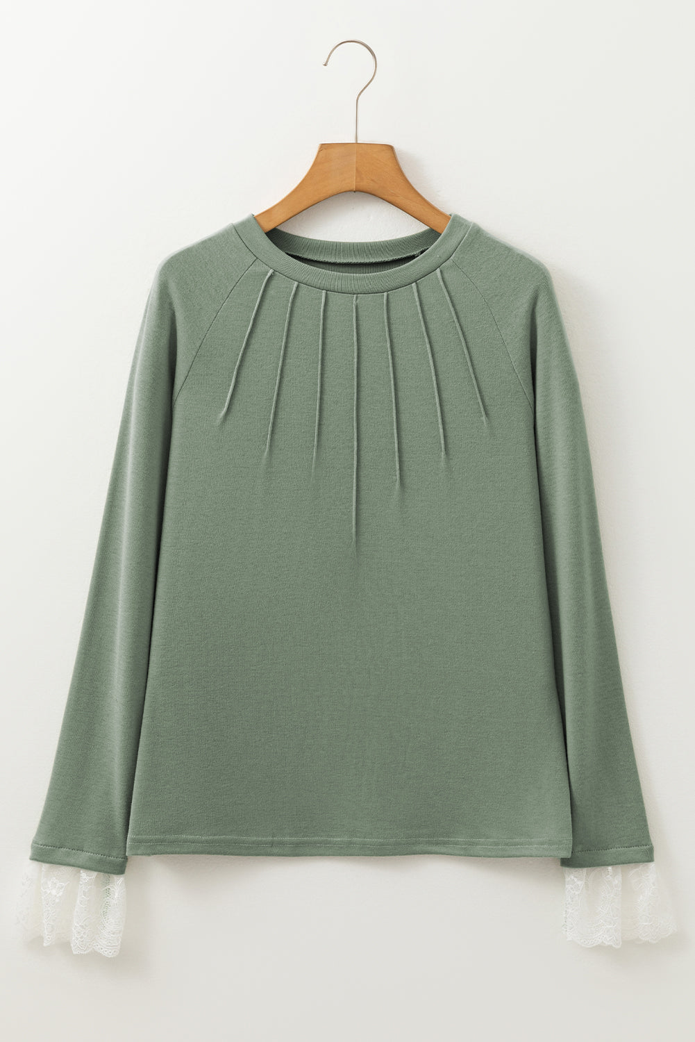 Grasgroene naad details kanten contrast manchetten raglan mouw top