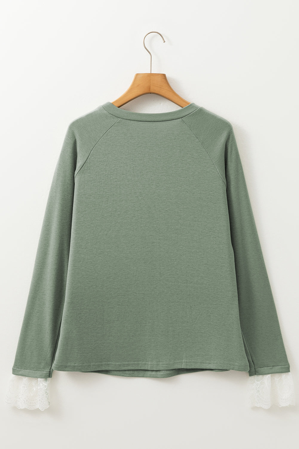 Grasgroene naad details kanten contrast manchetten raglan mouw top