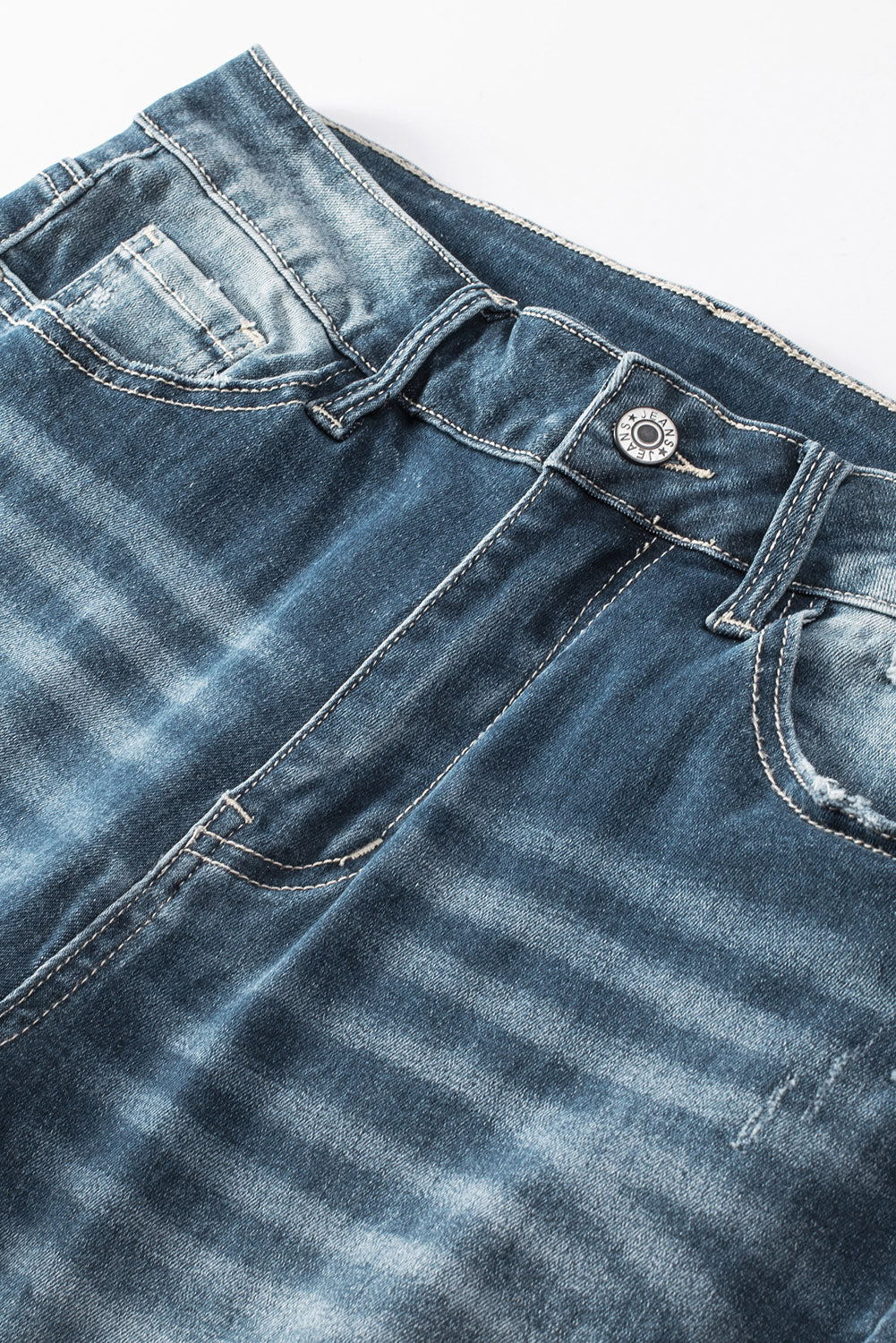 Blauwe noodlijdende gescheurde skinny jeans